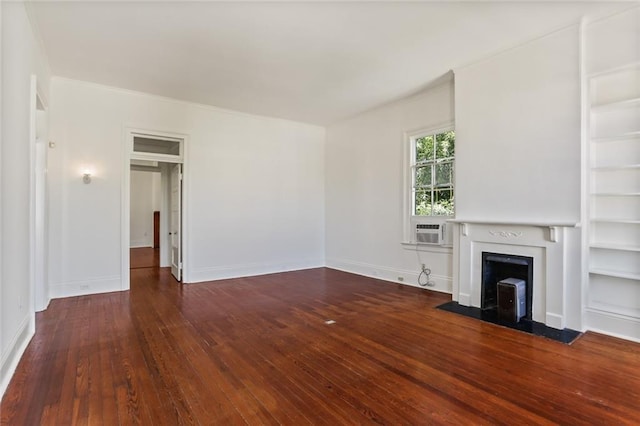 unfurnished living room featuring dark wood-type flooring, cooling unit, and built in features