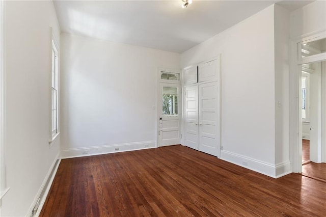 unfurnished bedroom with wood-type flooring and a closet