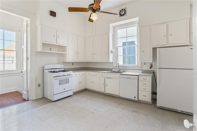 kitchen featuring white appliances, ceiling fan, white cabinetry, and sink