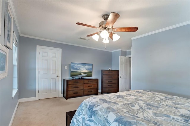 carpeted bedroom featuring ceiling fan and crown molding