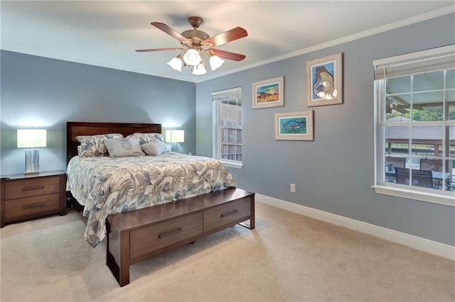 carpeted bedroom featuring ceiling fan and crown molding