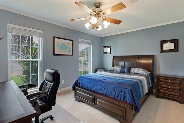 carpeted bedroom featuring ceiling fan and crown molding