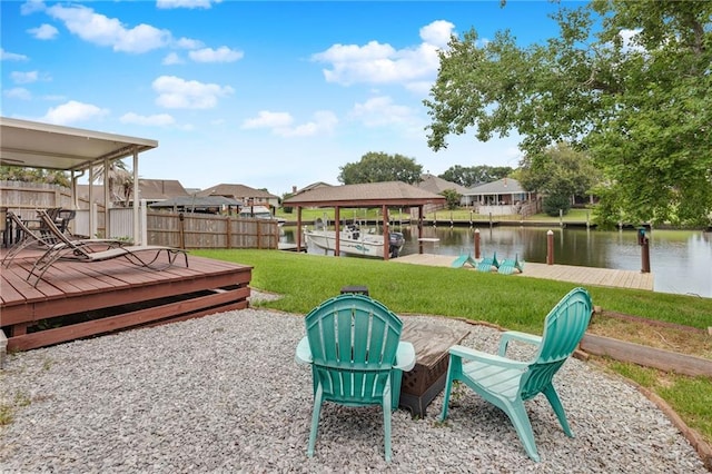 view of yard with a water view and a dock