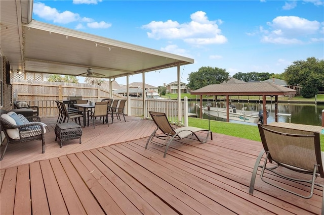 deck with a dock and a water view