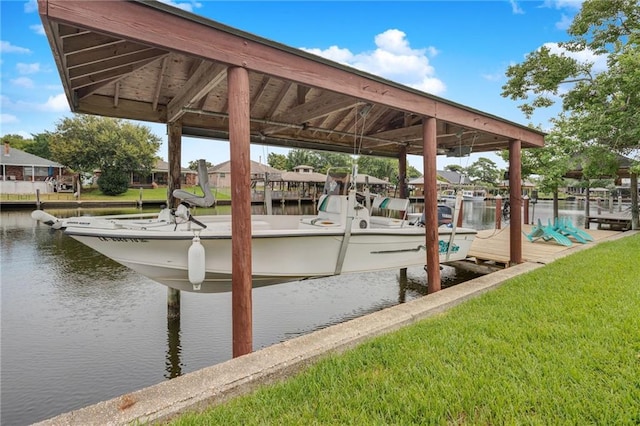 dock area featuring a lawn and a water view