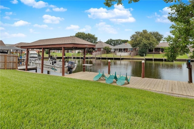 view of dock with a lawn and a water view