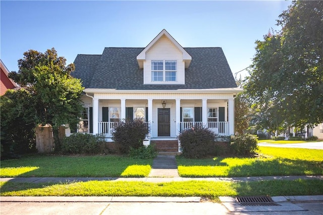 view of front facade featuring covered porch and a front yard