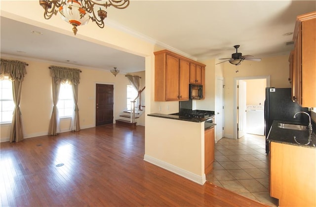 kitchen featuring ceiling fan with notable chandelier, crown molding, sink, and light hardwood / wood-style flooring