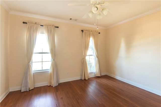 unfurnished room with dark hardwood / wood-style flooring, crown molding, and a wealth of natural light