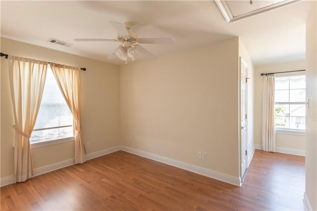 spare room with wood-type flooring and ceiling fan