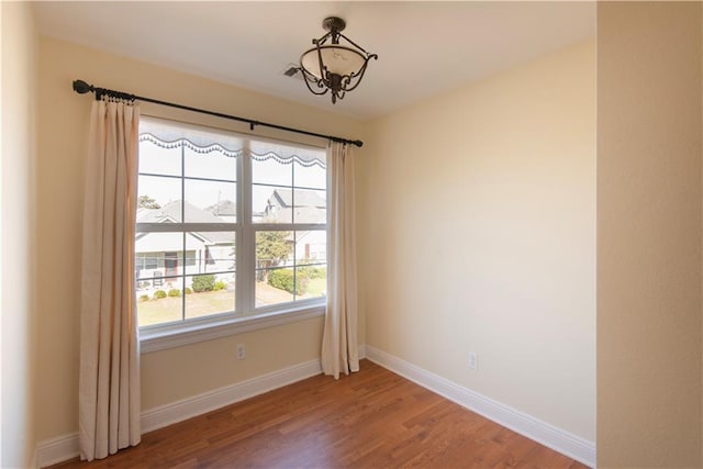 unfurnished room with hardwood / wood-style floors