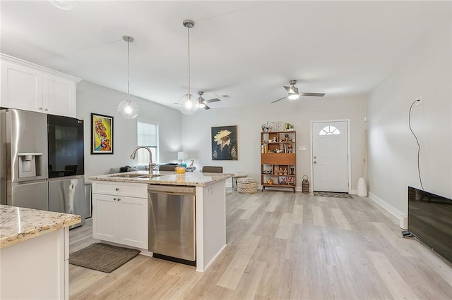 kitchen featuring sink, appliances with stainless steel finishes, white cabinetry, and light hardwood / wood-style floors