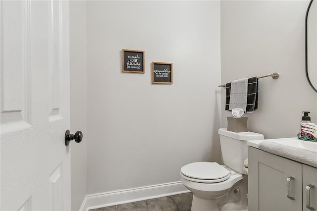 bathroom featuring vanity, toilet, and tile patterned flooring