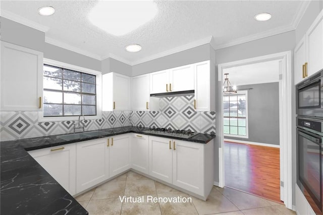 kitchen with white cabinets, tasteful backsplash, and dark stone counters