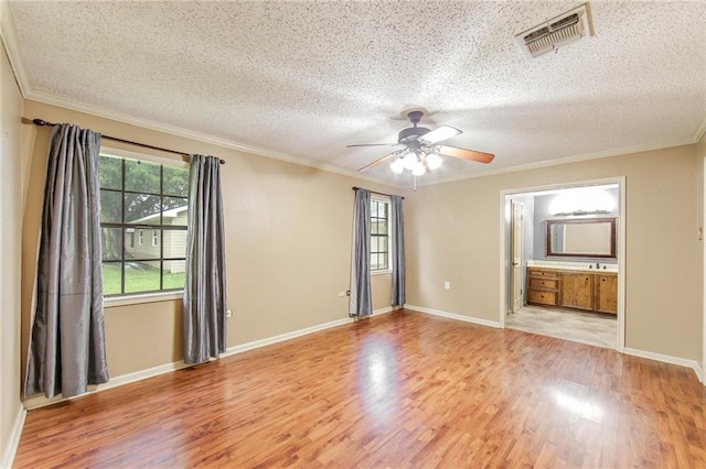 unfurnished room with crown molding, light hardwood / wood-style flooring, a textured ceiling, and ceiling fan