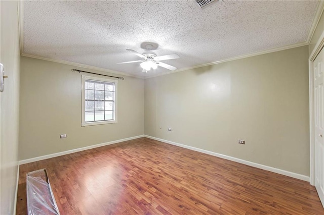 spare room with hardwood / wood-style floors, a textured ceiling, and ceiling fan