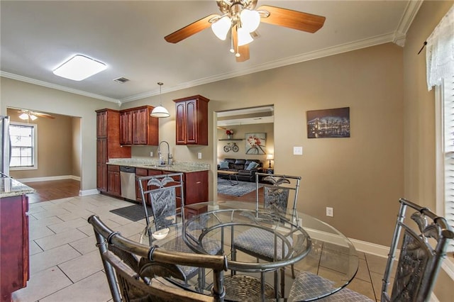 dining room with ornamental molding, sink, light tile patterned floors, and ceiling fan