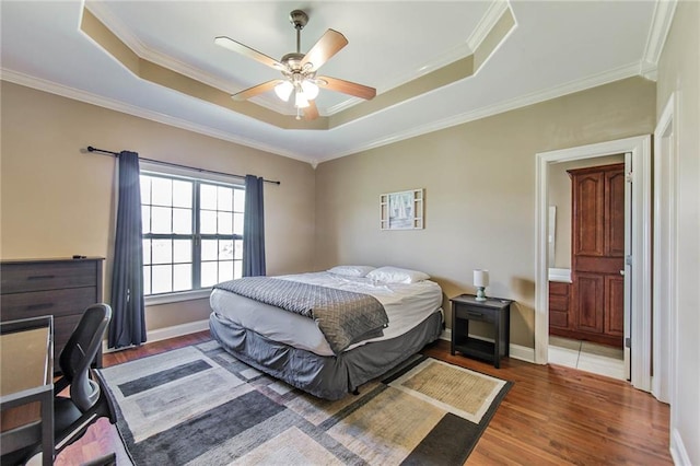 bedroom with dark wood-type flooring, crown molding, and ceiling fan