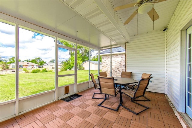 sunroom / solarium featuring ceiling fan