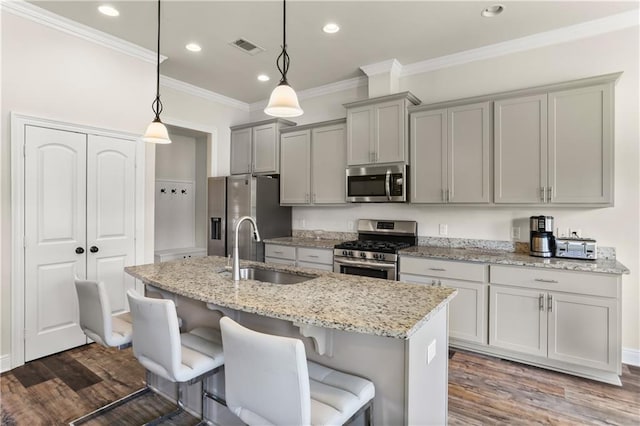 kitchen featuring appliances with stainless steel finishes, dark hardwood / wood-style floors, sink, and hanging light fixtures