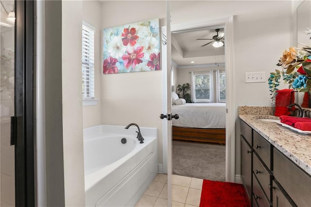 bathroom with vanity, a tub, tile patterned flooring, and ceiling fan