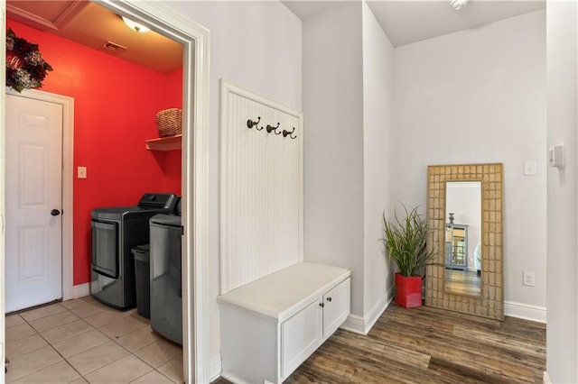 mudroom with independent washer and dryer and light wood-type flooring