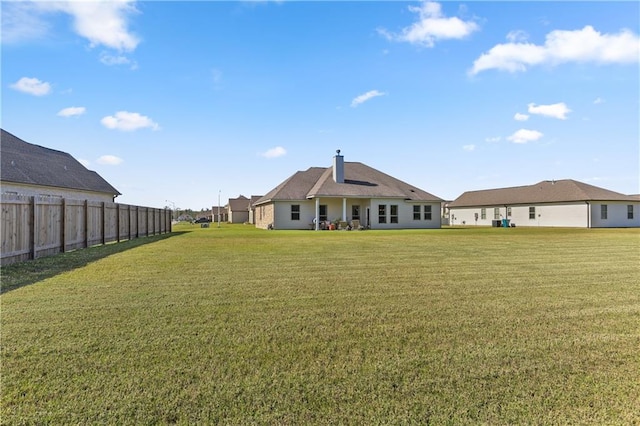 rear view of house with a lawn