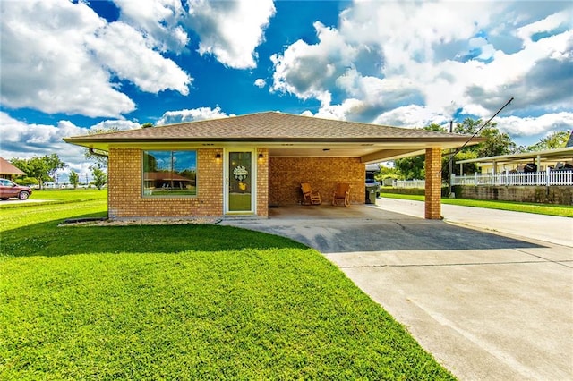 view of front of property with a front lawn and a carport