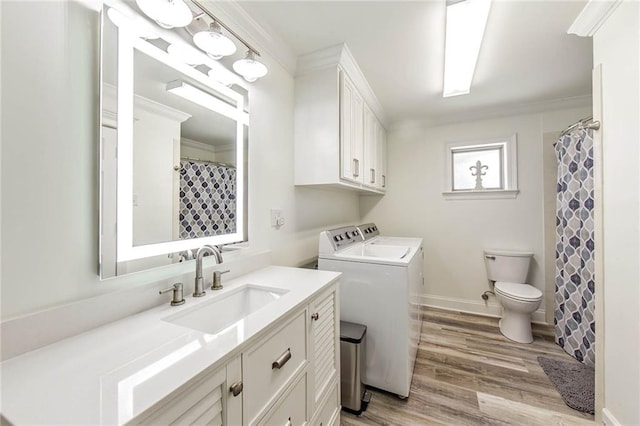 1353 Doctor Beatrous Rd, Theriot, LA 70397 - bathroom with hardwood / wood-style floors, separate washer and dryer, toilet, ornamental molding, and vanity