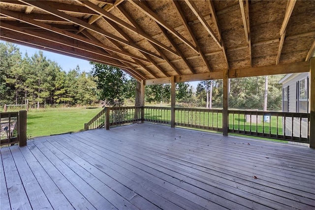 wooden terrace featuring a yard