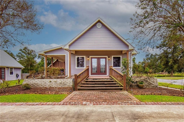 bungalow-style home featuring a porch and french doors