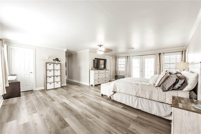 bedroom with baseboards, light wood-style floors, access to outside, french doors, and crown molding