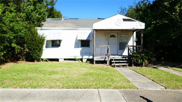 bungalow-style home featuring a front yard