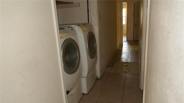 laundry room featuring dark tile patterned floors and washer and clothes dryer