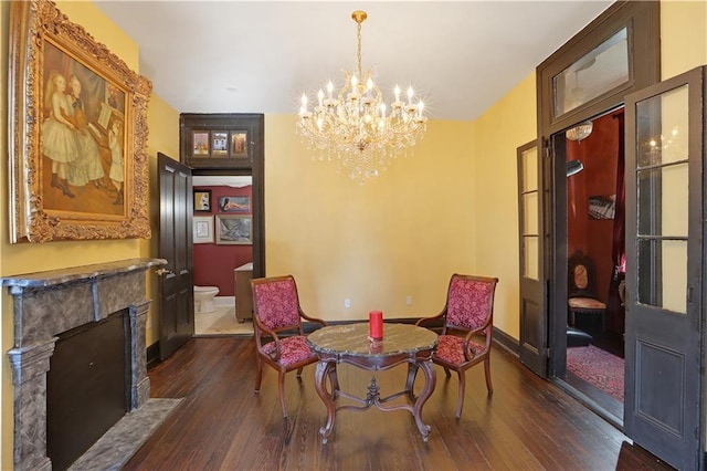 dining room featuring dark hardwood / wood-style floors and an inviting chandelier