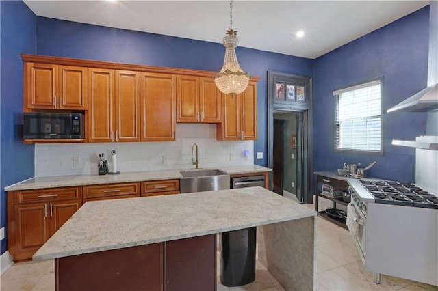 kitchen with sink, a center island, gas range gas stove, decorative light fixtures, and black microwave