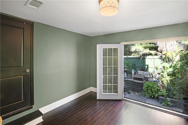 unfurnished room with dark hardwood / wood-style floors