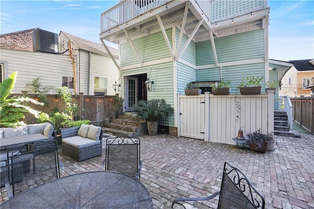 rear view of house with a patio and a balcony