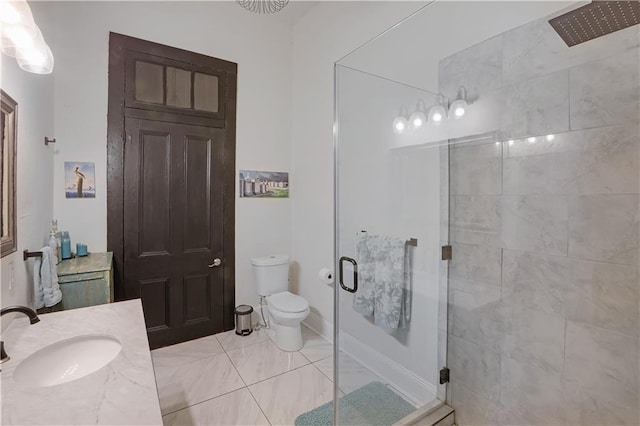 bathroom featuring vanity, a shower with shower door, and toilet