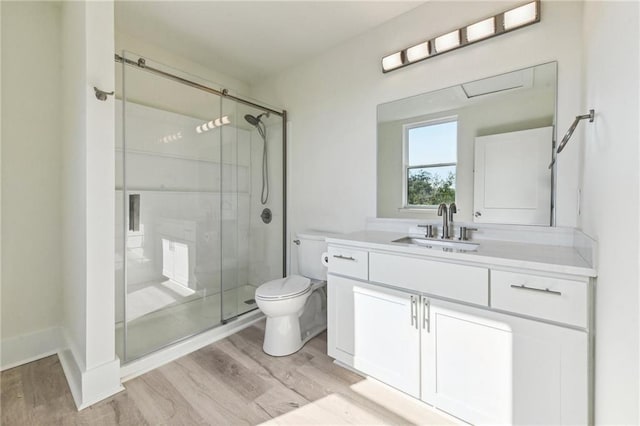 bathroom with vanity, hardwood / wood-style floors, toilet, and walk in shower