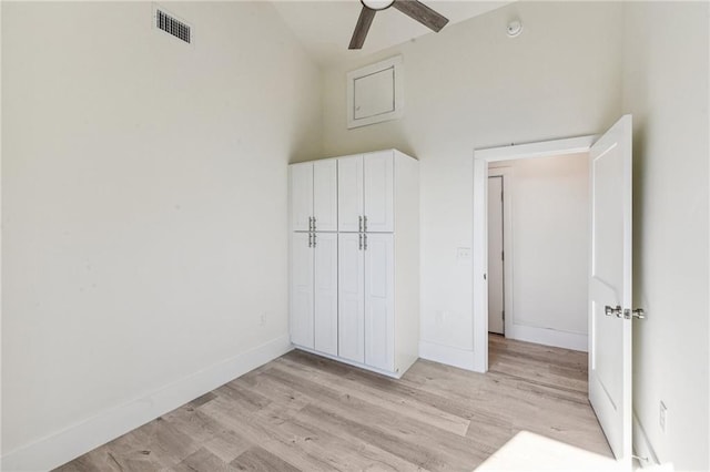 unfurnished bedroom with light hardwood / wood-style floors, a closet, and ceiling fan