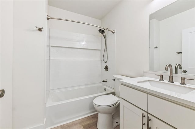 full bathroom featuring vanity, toilet, hardwood / wood-style flooring, and bathing tub / shower combination