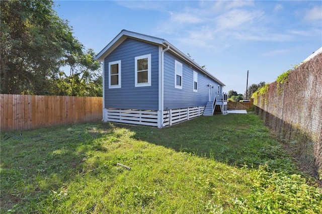 5017 N Miro St, New Orleans, LA 70117 - view of property exterior featuring stairs, a lawn, and a fenced backyard