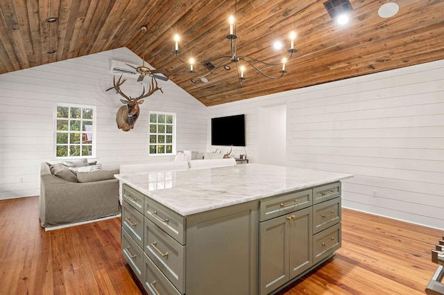 kitchen with a center island, wood ceiling, light wood-type flooring, and wood walls