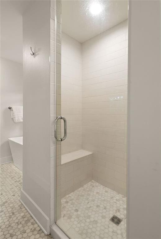 bathroom featuring independent shower and bath