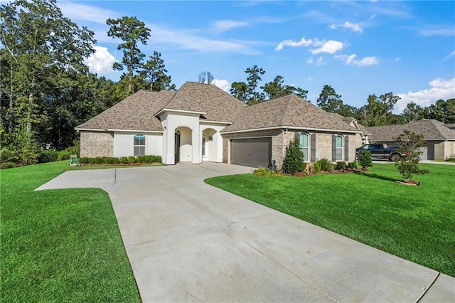 view of front of property with a front yard and a garage