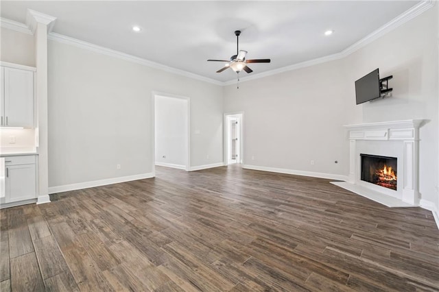 unfurnished living room featuring crown molding, dark wood-type flooring, and ceiling fan