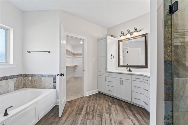 bathroom featuring vanity, independent shower and bath, and hardwood / wood-style flooring