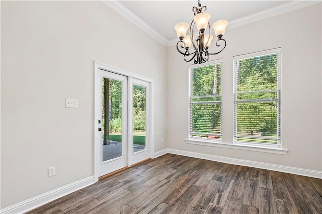 unfurnished room with ornamental molding, an inviting chandelier, and hardwood / wood-style floors