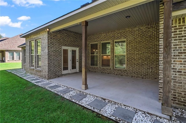 exterior space featuring a patio area and a lawn